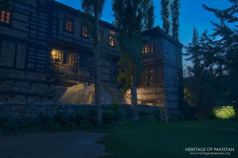 Shigar Fort glows warmly as twilight falls on its timber-framed walls.